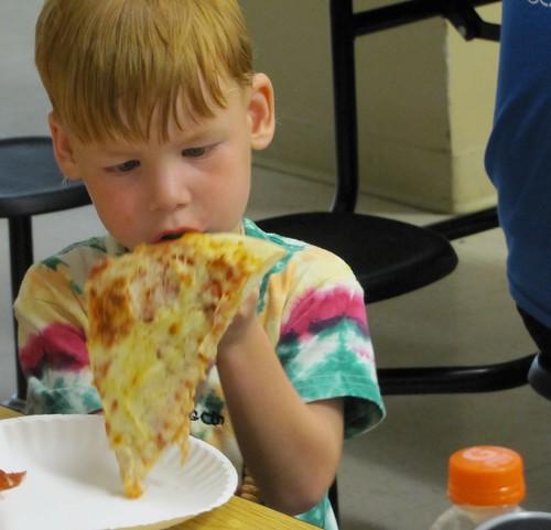 Pizza party by Clarkston SCAMP kid eating pizza photo