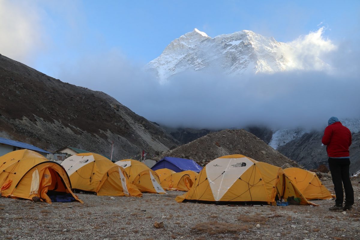 a man standing in front of a group of tents