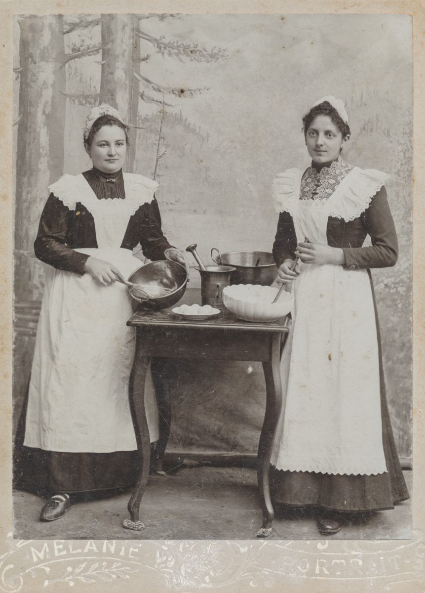 Two women with cooking utensils
