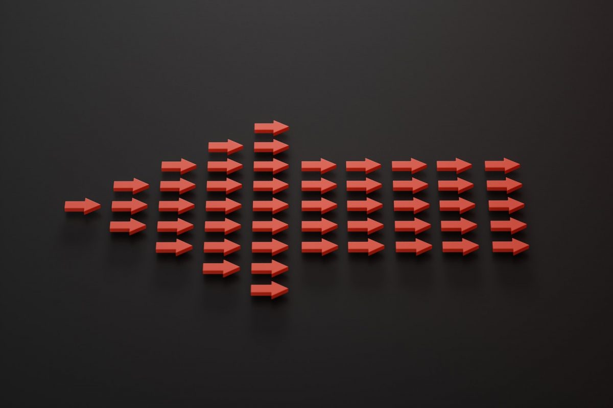 a group of red arrows on a black surface