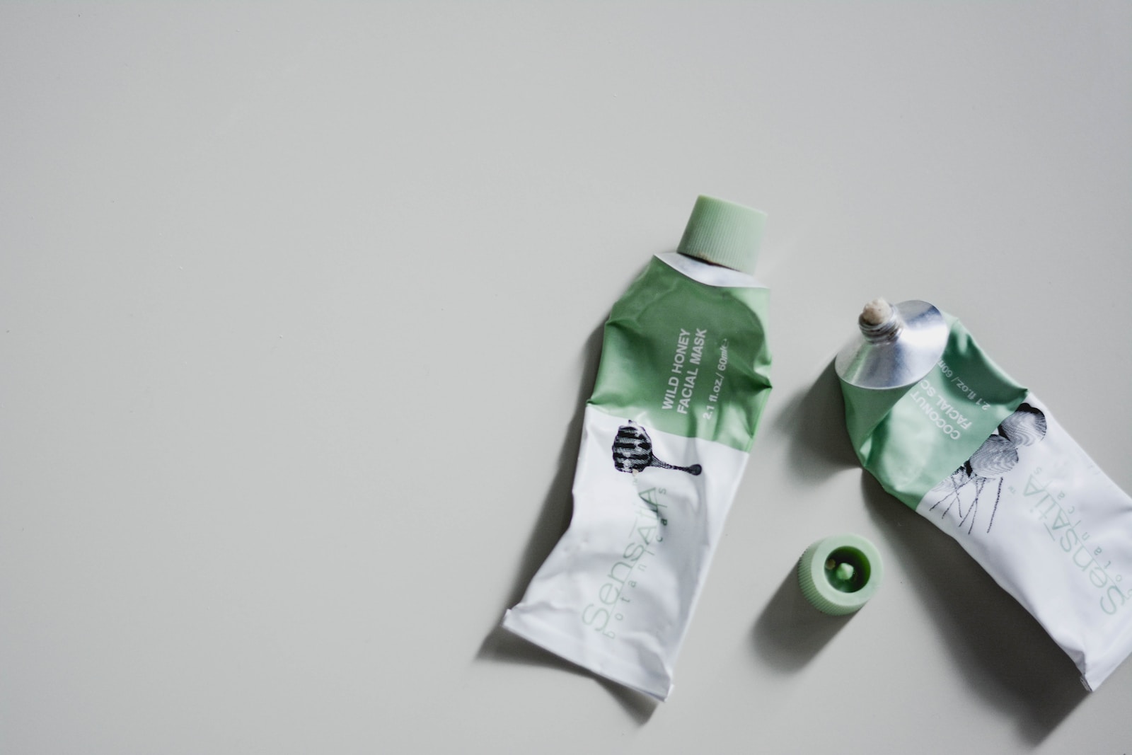 white and green tube bottle