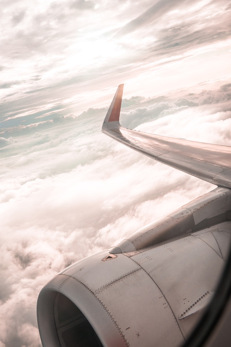 Airplane over White Clouds