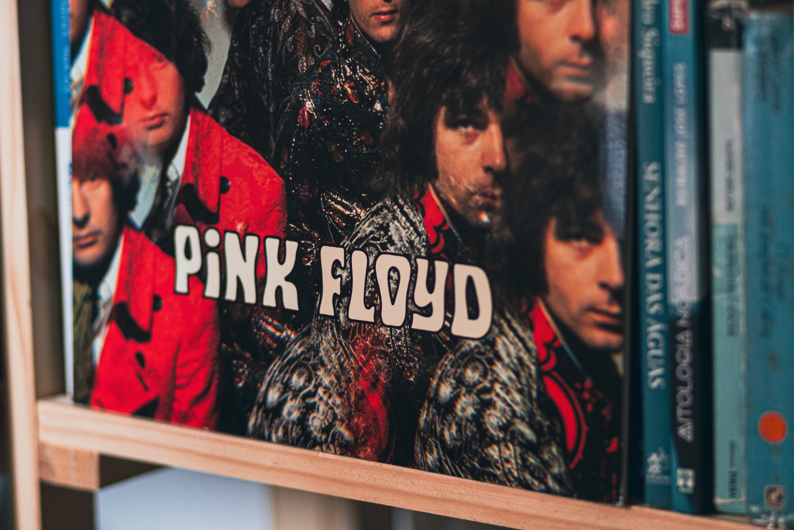 a book shelf with a pink floyd album on it