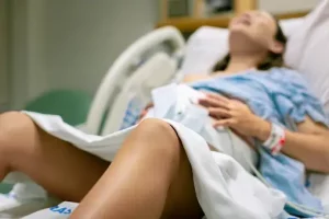 a woman in labor with painful contractions lying in the hospital bed childbirth and baby