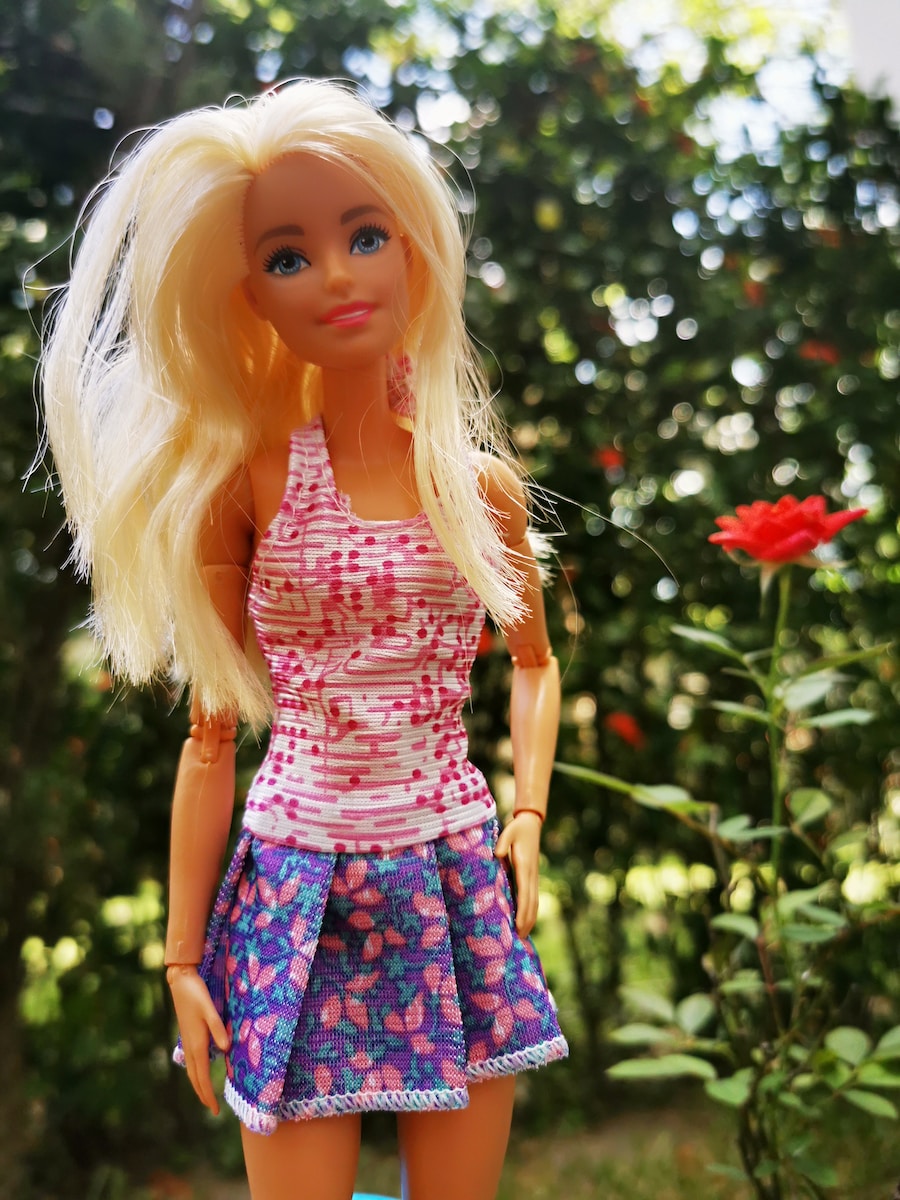 blonde haired girl in red and blue floral dress