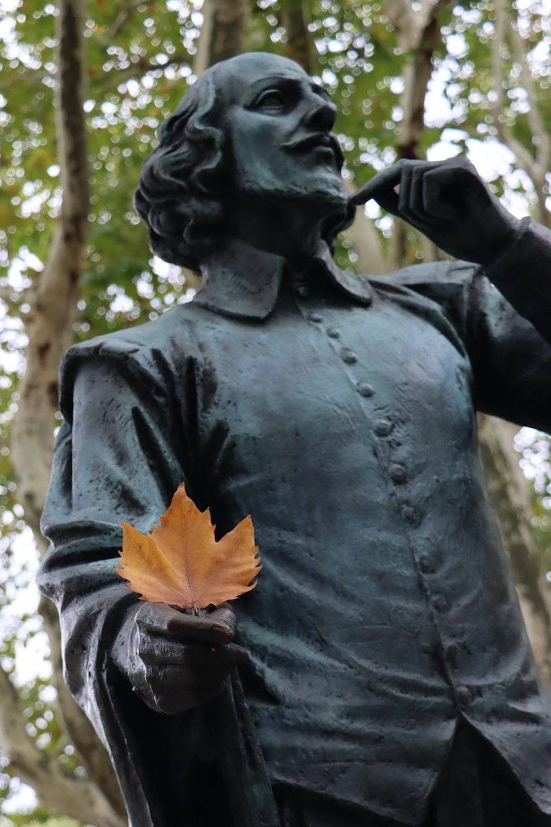 a statue of a man with a leaf in his hand