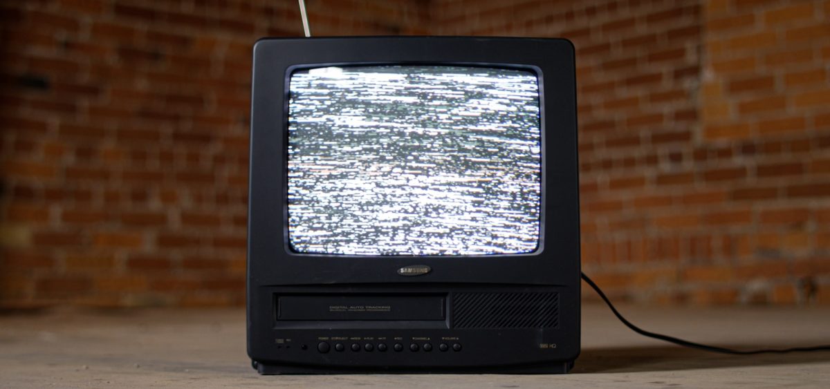 black crt tv on brown wooden table