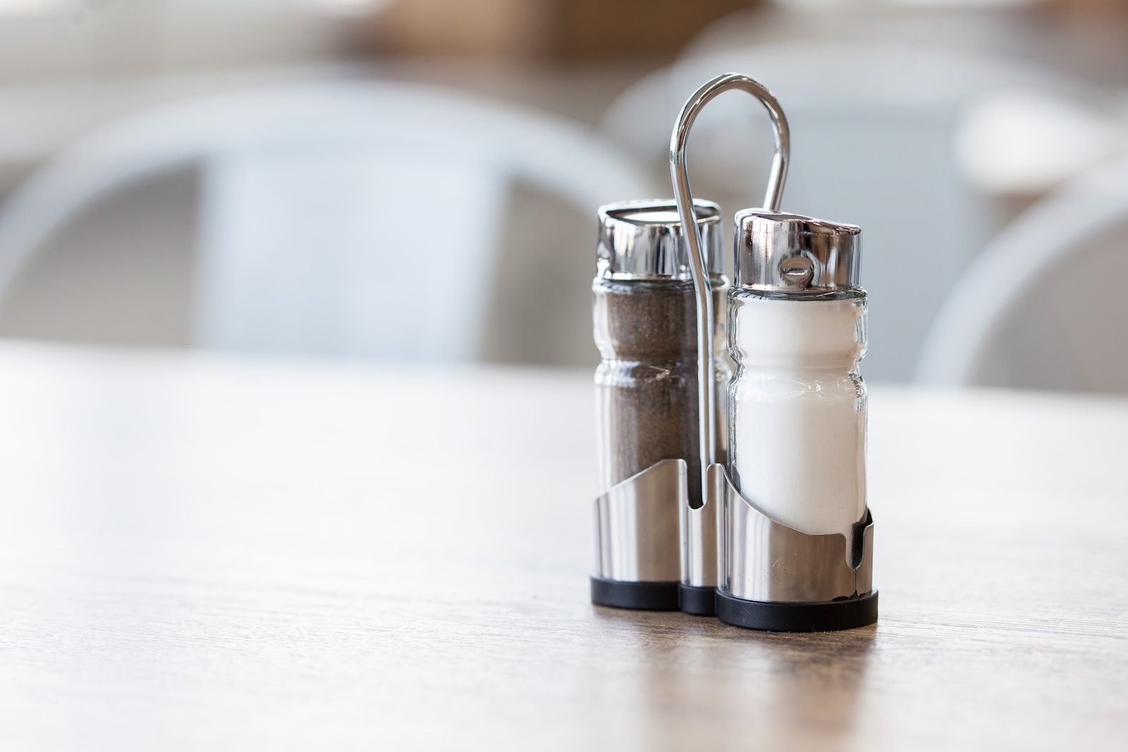 Salt and pepper shakers in holder on table