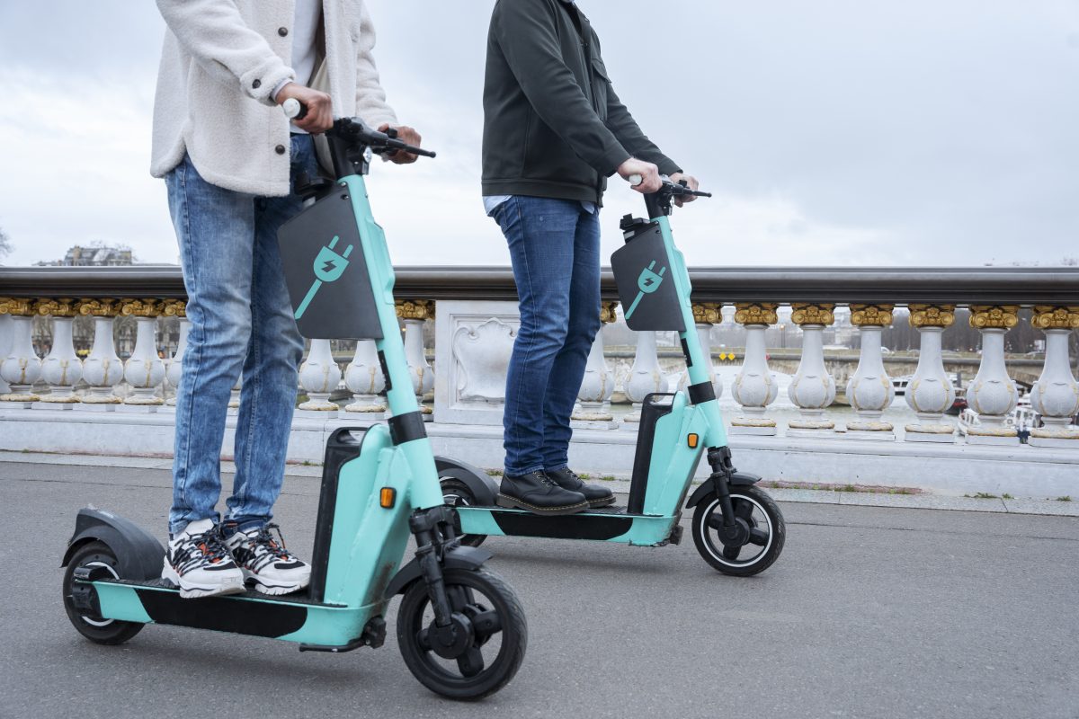 adults learning use electric scooter