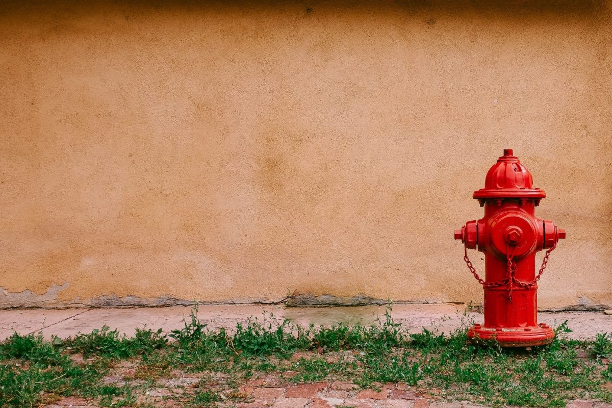 fire hydrant near beige painted wall