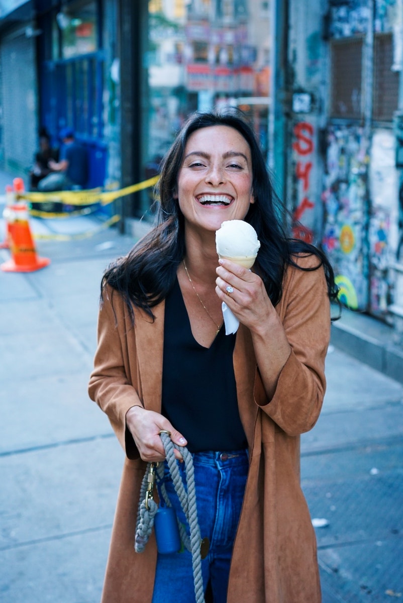 Woman Wearing Brown Trench Coat While Holding Ice Cream