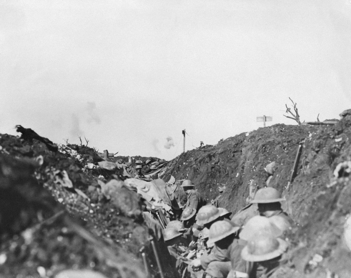 a black and white photo of soldiers in a trench