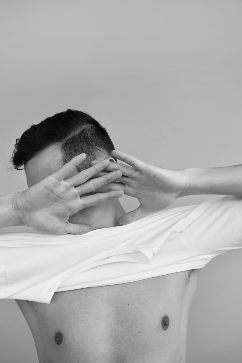 Grayscale Studio Shoot of a Man with Bare Torso and Obscured Face