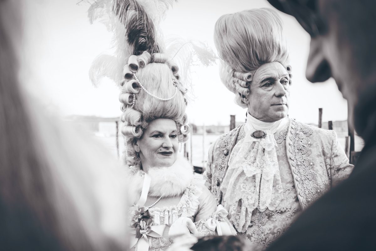 black and white photography of man and woman in costume