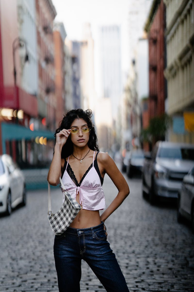 Young Girl in Trendy Outfit Posing on a City Street