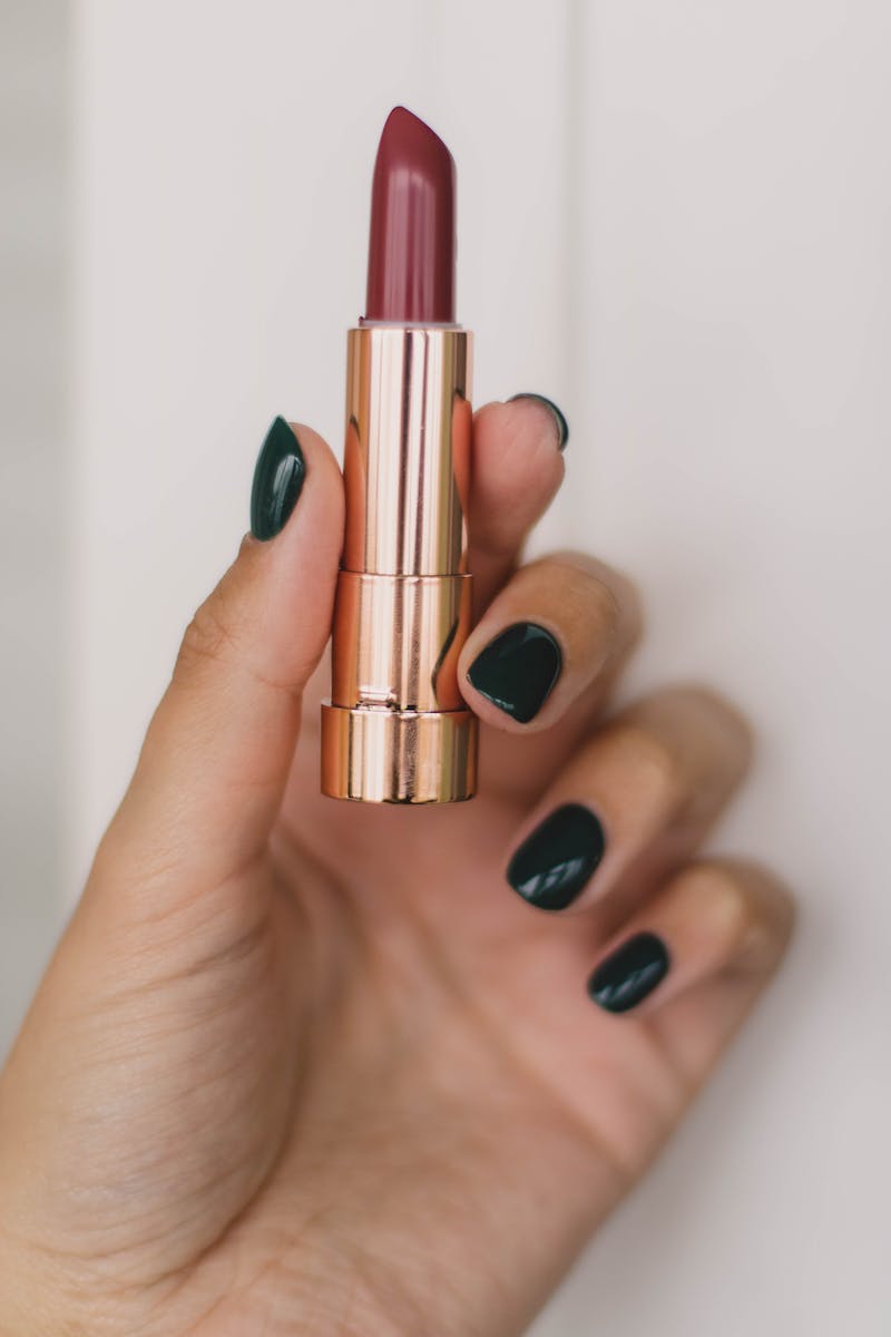 Close-Up Photo Of Person Holding Lipstick