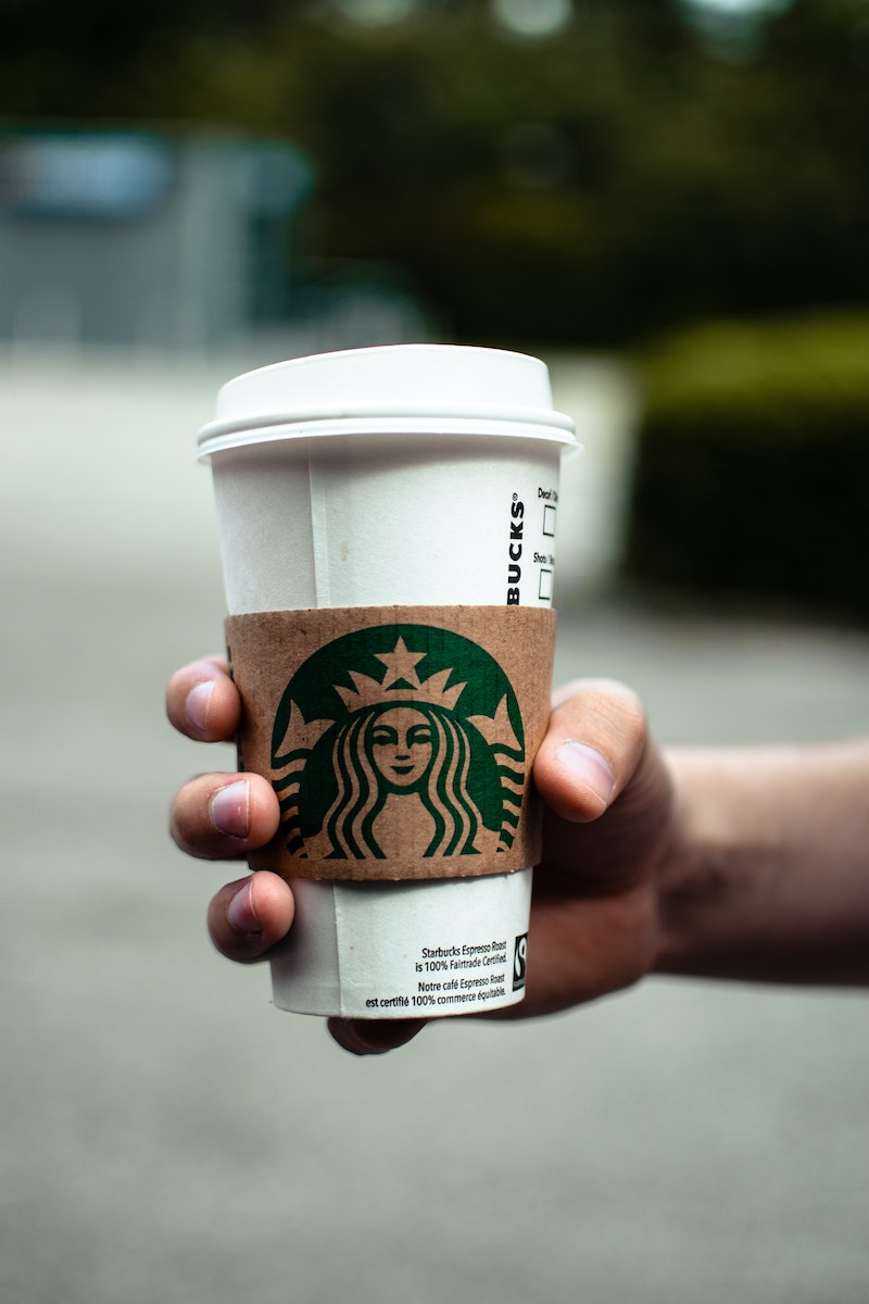 A Person Holding a Hot Starbucks Coffee