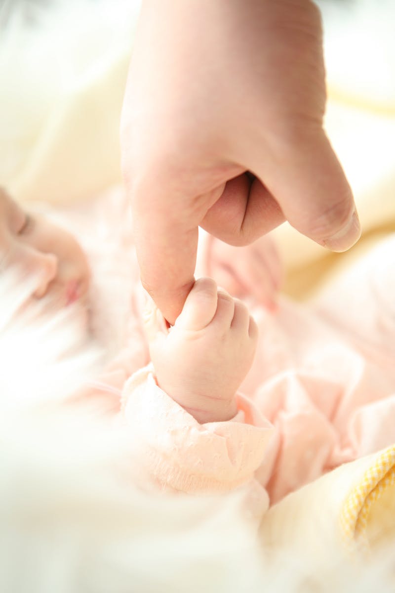 Baby Holding Person's Index Finger