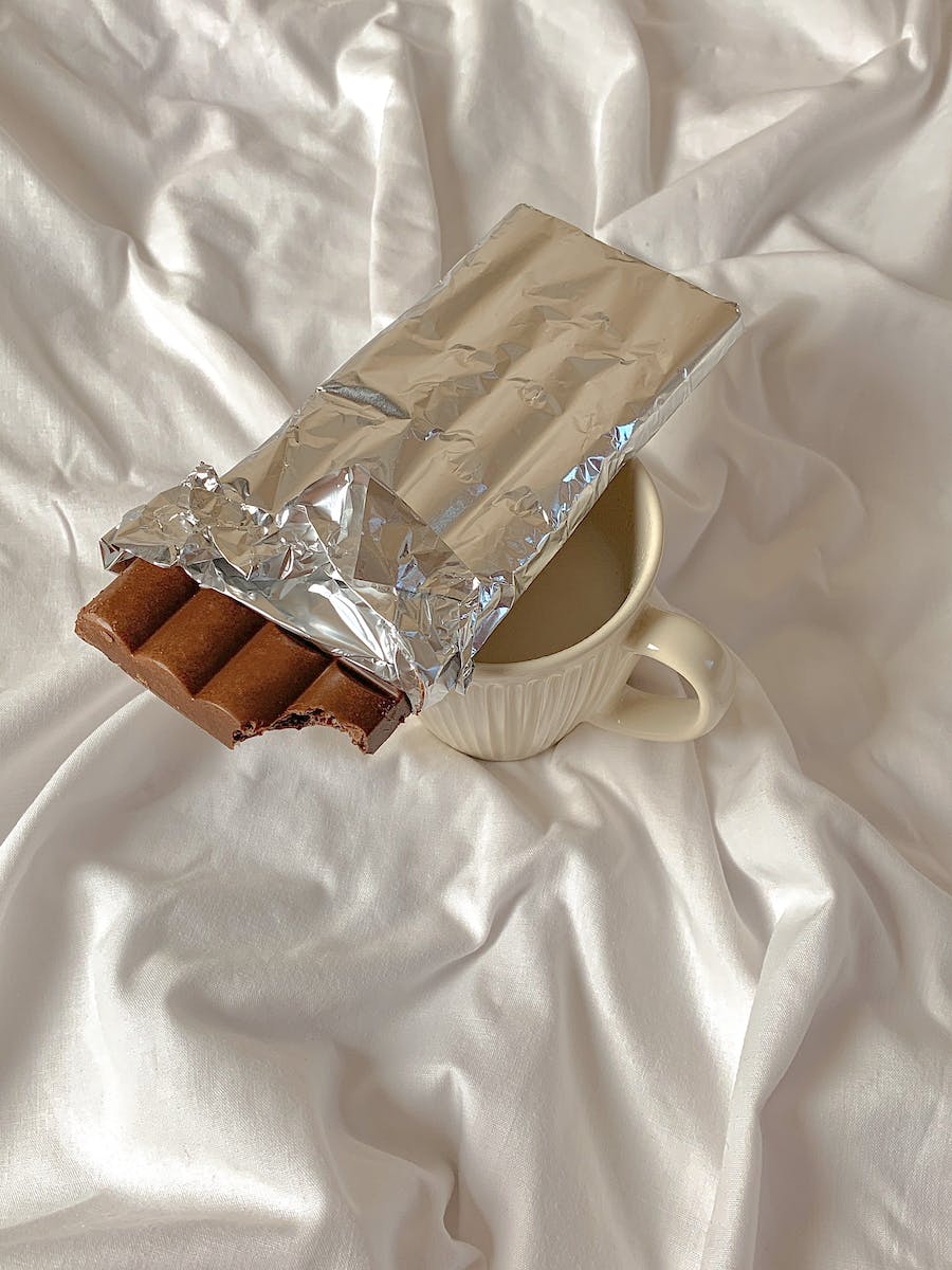Chocolate Wrapped in Aluminum Foil on a Ceramic Cup