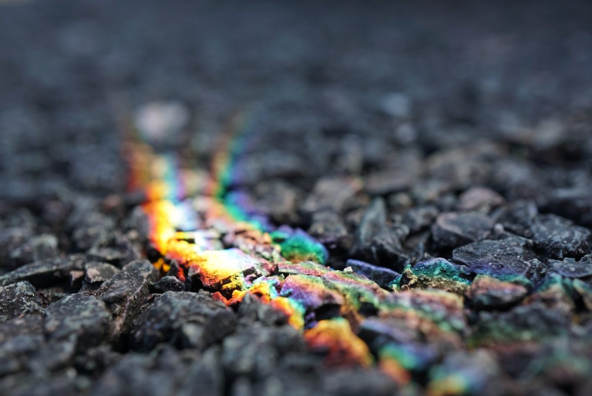 a close up of a rainbow colored object on the ground