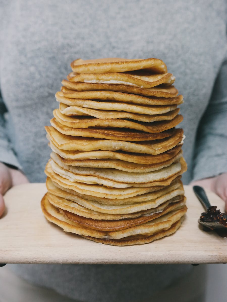 Person Holding Board With Pancakes