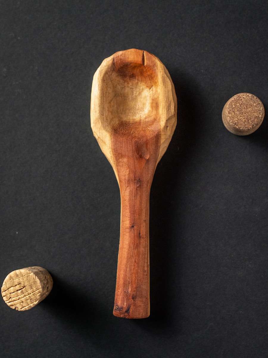 brown wooden spoon on black textile