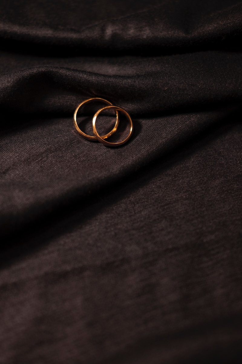 gold ring on black textile