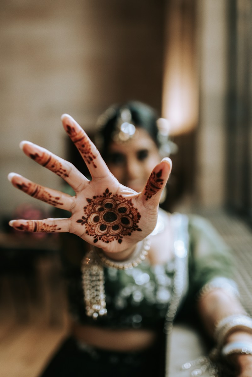 a woman with her hands painted with henna