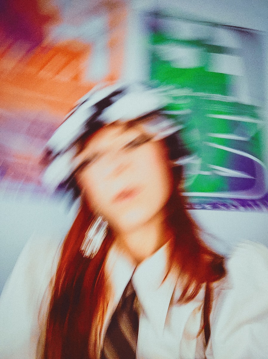 a blurry photo of a woman wearing a hat
