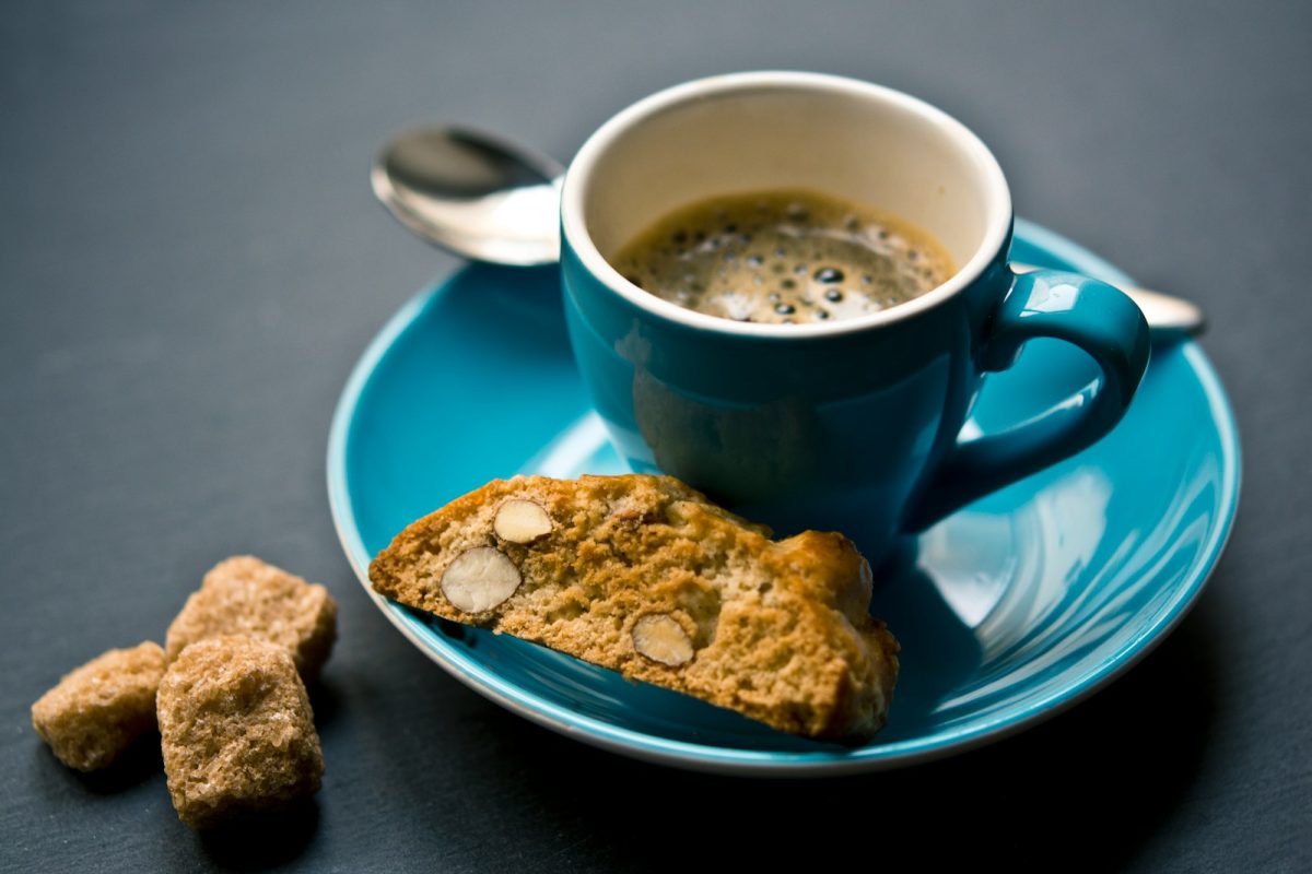 cup of coffee and bread on saucer closeup photography