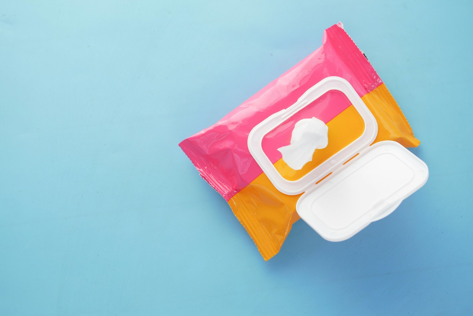 a pink and yellow bag of food on a blue surface