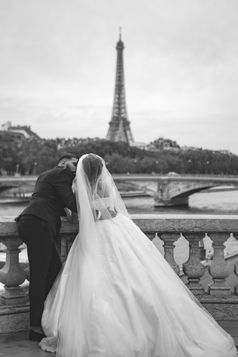 grayscale photography of wedding couple in front of Eiffel Tower