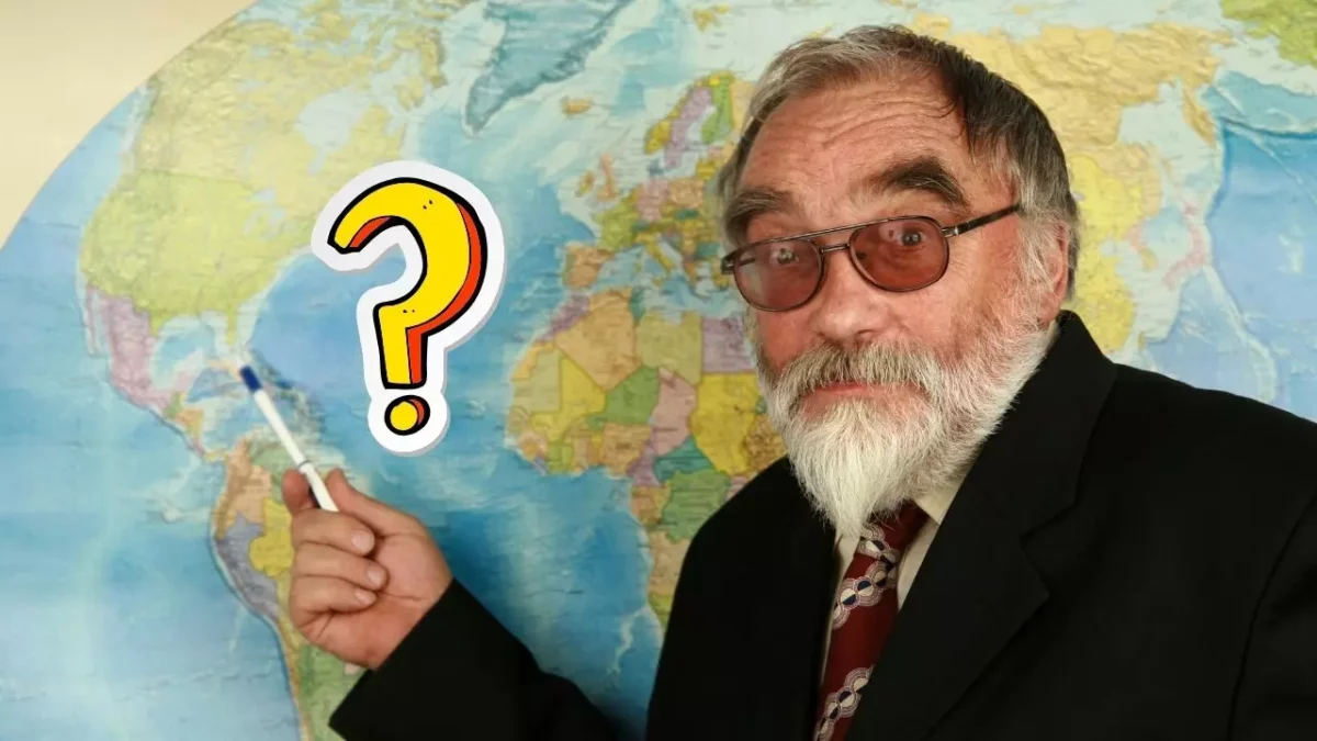 Muž s bradou ukazuje na mapu s otáznikom, symbolizuje geografickú hádanku.