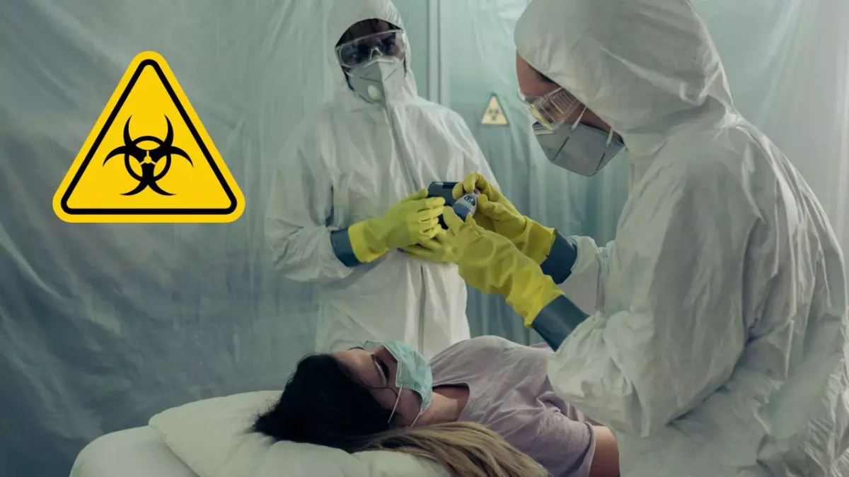 Zdravotníci v ochranných oblekoch pracujú v izolovanej zóne s biohazard symbolom, pacientka leží v maske.