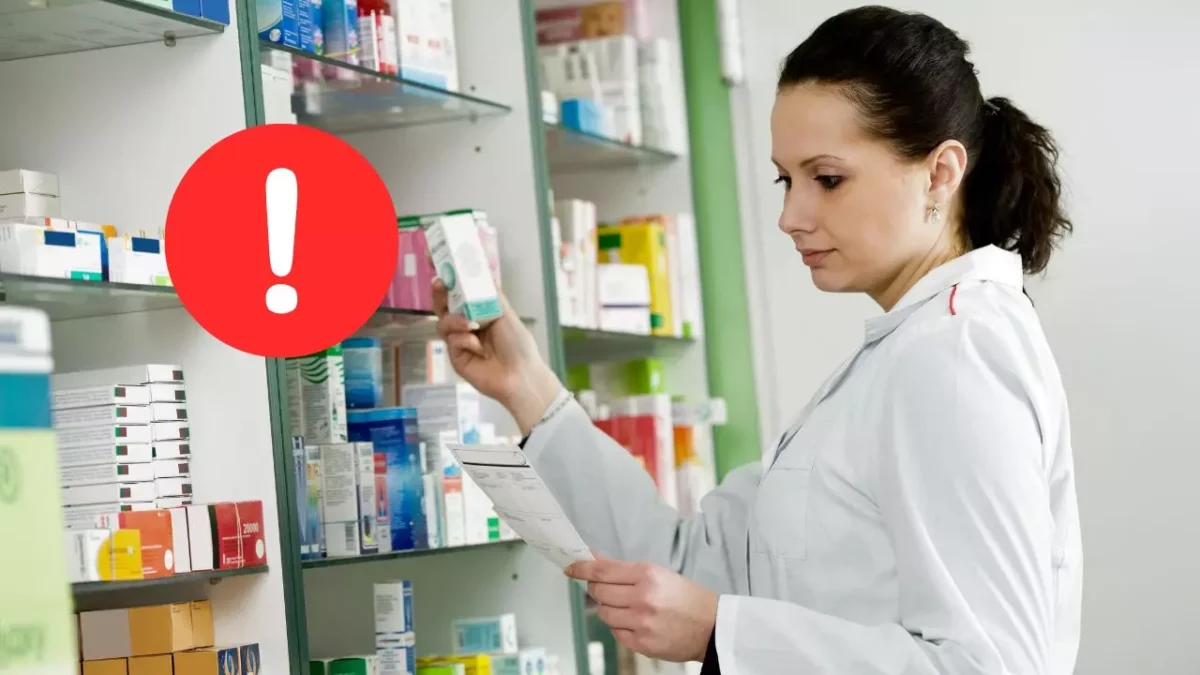 Farmaceutka kontroluje lieky v lekárni, vedľa je upozornenie v červenom kruhu.