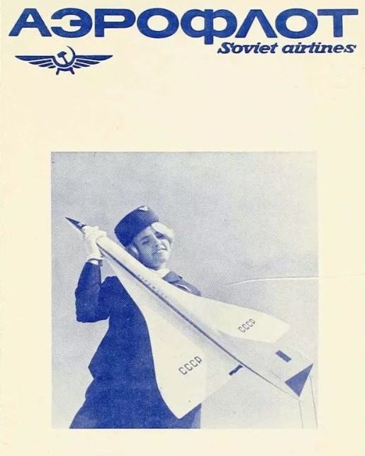 Letuška predstiera lietanie s modelom lietadla značky CCCP na retro Aeroflot plagáte.