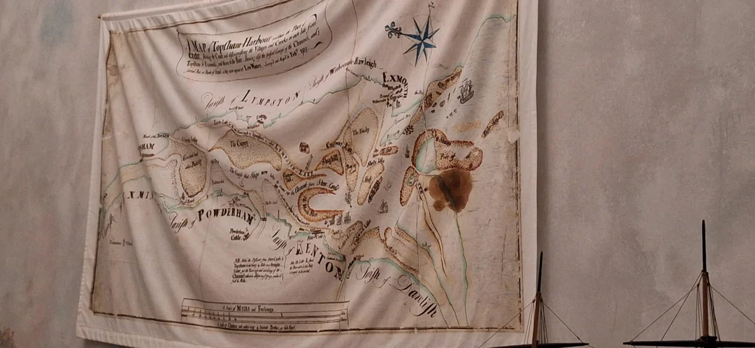 Stará nástenná mapa prístavu z 19. storočia zobrazuje historickú navigačnú oblasť pri pobreží s kompasovou ružicou.