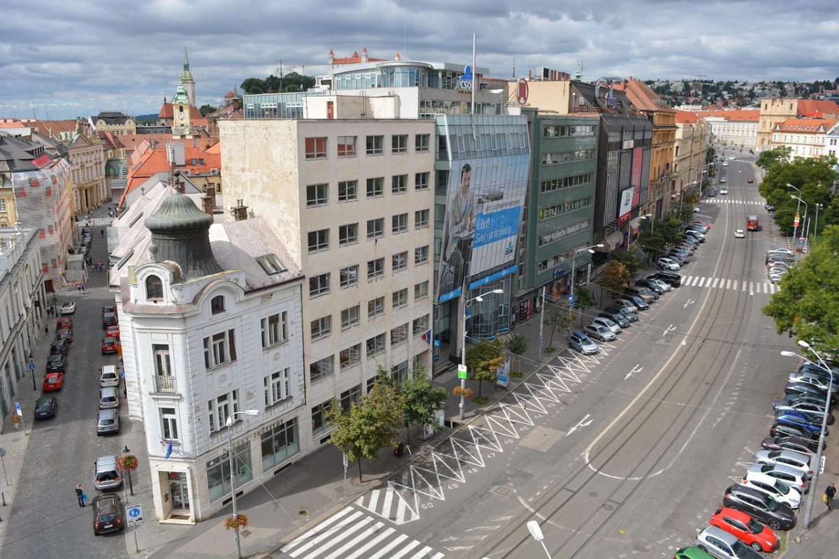 Historické centrum mesta s modernou architektúrou, život v uliciach plných áut a ľudí, krásna mestská scenéria.