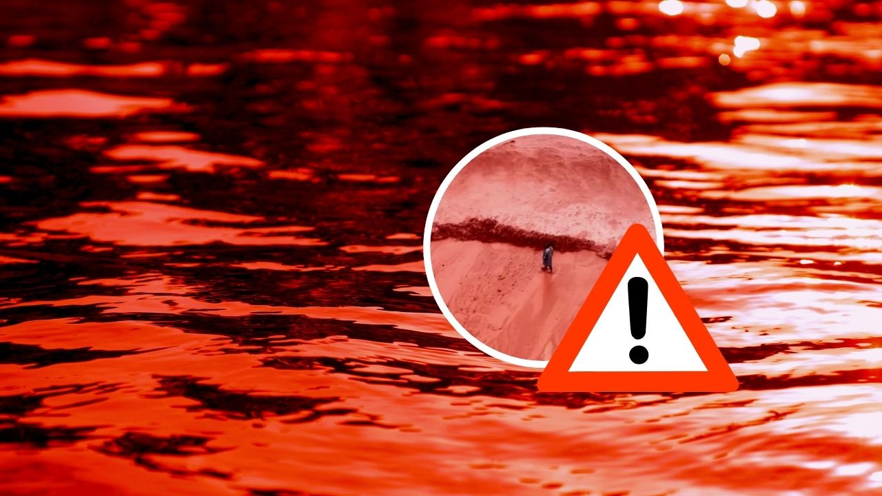 Hladina vody zafarbená červenou, detail s výkričníkom naznačuje varovanie alebo nebezpečenstvo.