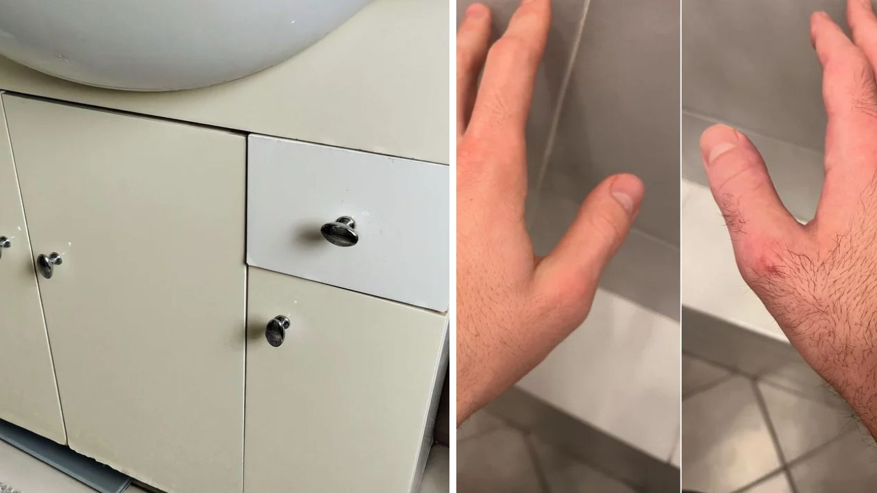 Biela kúpeľňová skrinka s rukoväťami a dlaždice. Detail ruky pri stene.