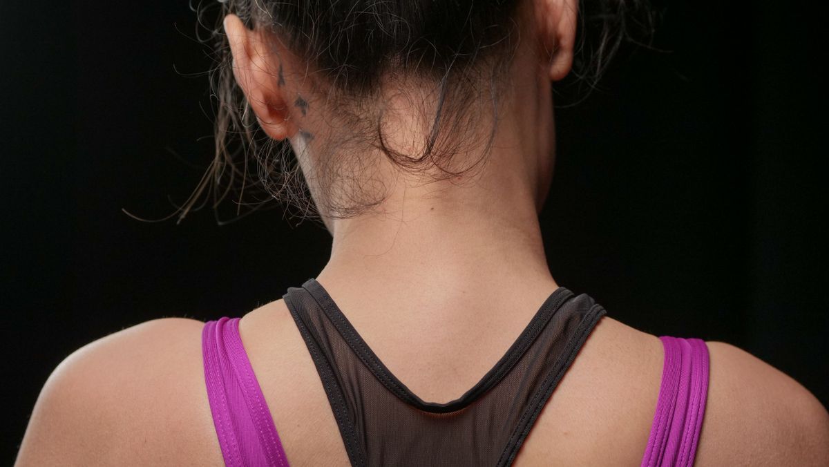 Close-up view of a woman's back wearing a sports tank top. Ideal for fitness and lifestyle themes.